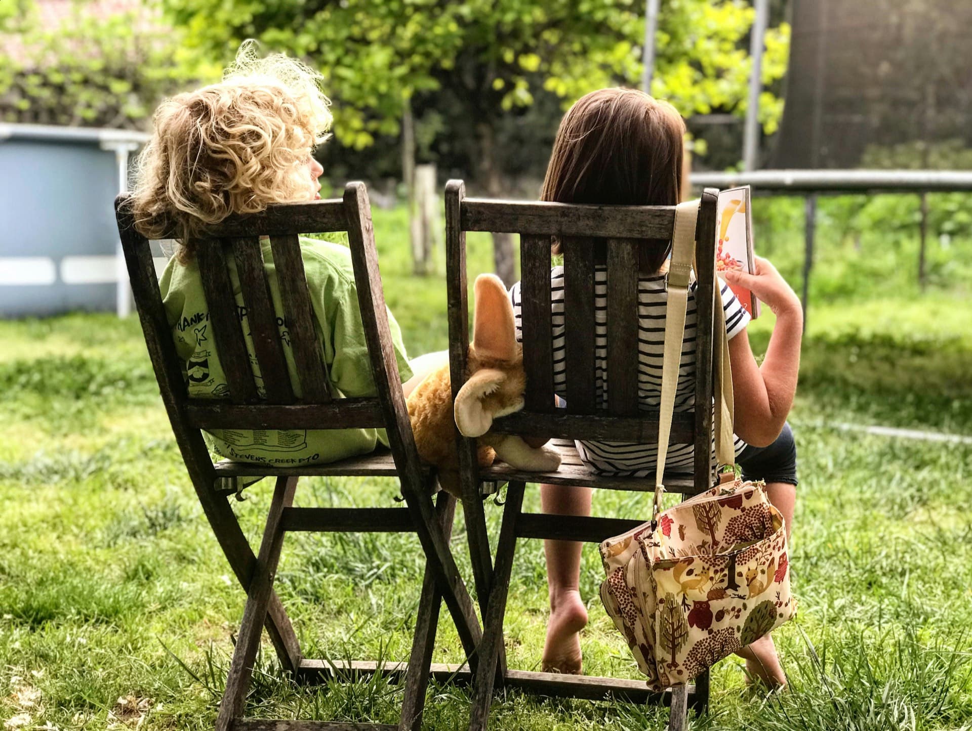 Two children relaxing outside in a shaded Voorhees, NJ backyard — the outdoor comfort families want back